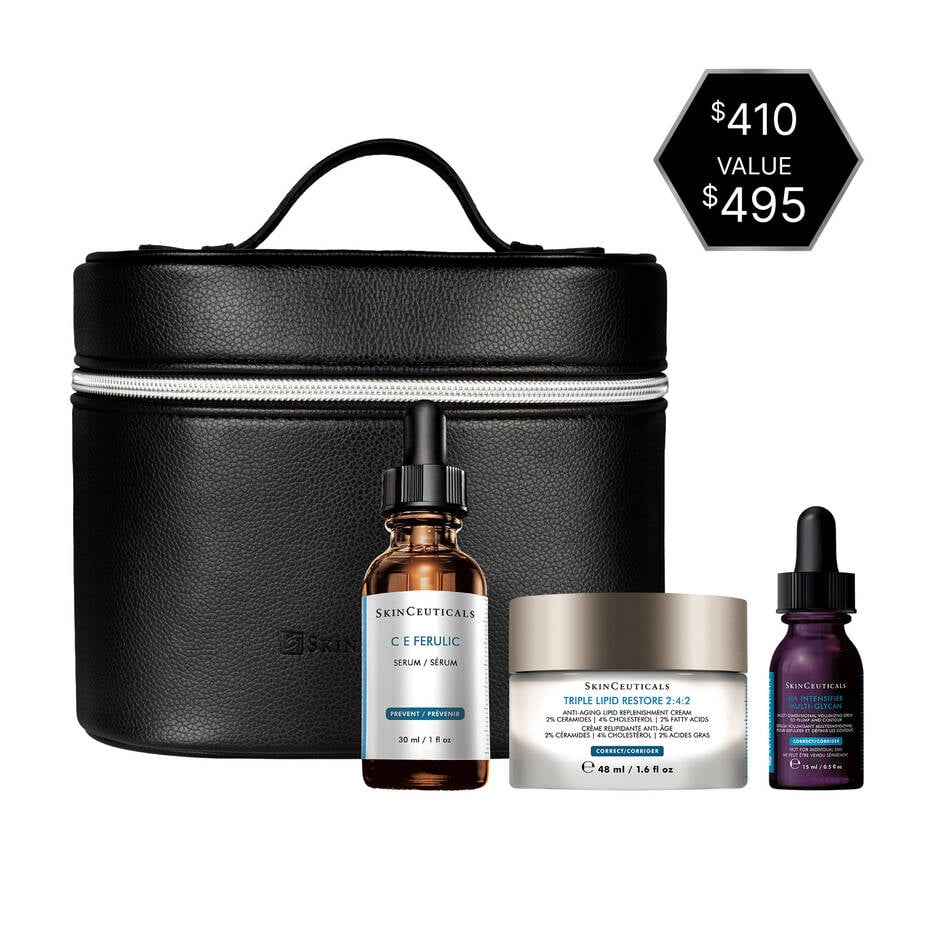 Set of skincare products including a black travel case, bottles, and a jar on a white background.
